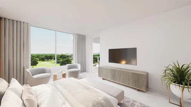 a bedroom with furniture a large window and a flat screen tv