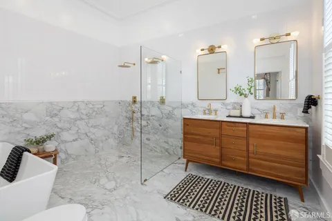a bathroom with a double vanity sink mirror and toilet