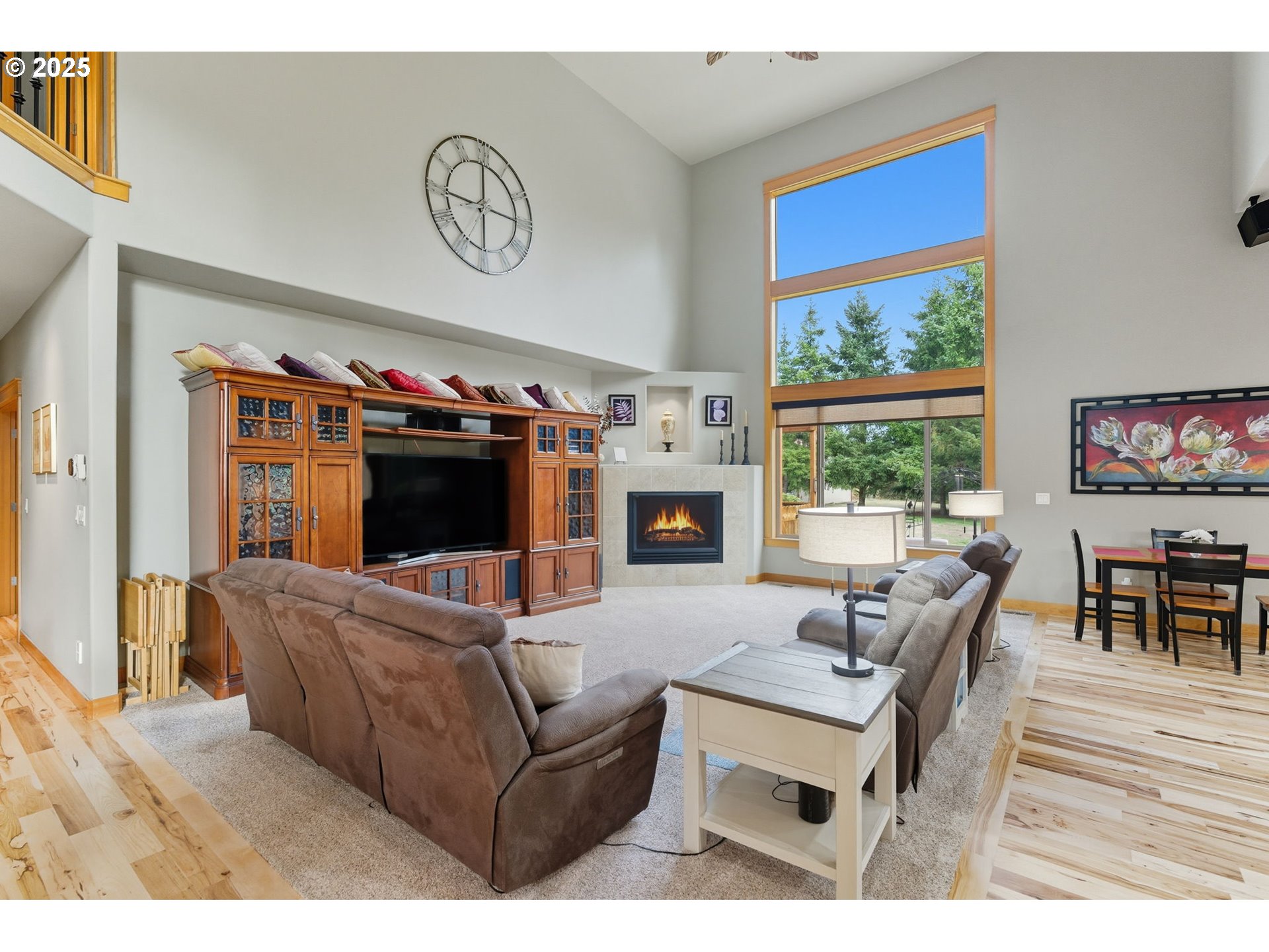 9573 South Gribble Road Canby, OR 97013 - Photo 12 of 48 a living room with furniture a flat screen tv and a floor to ceiling window