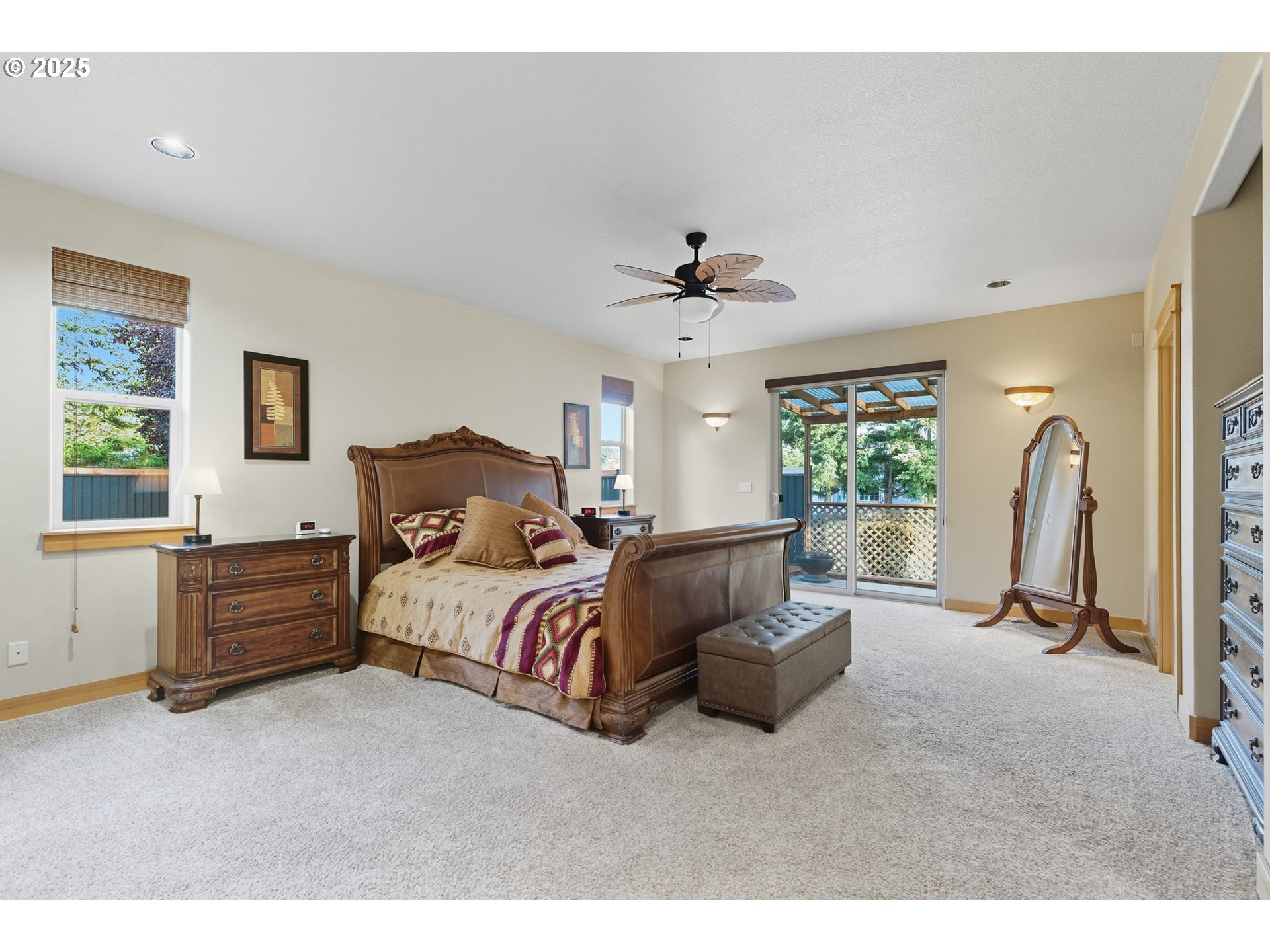 9573 South Gribble Road Canby, OR 97013 - Photo 23 of 48 a spacious bedroom with a bed a couch and a window