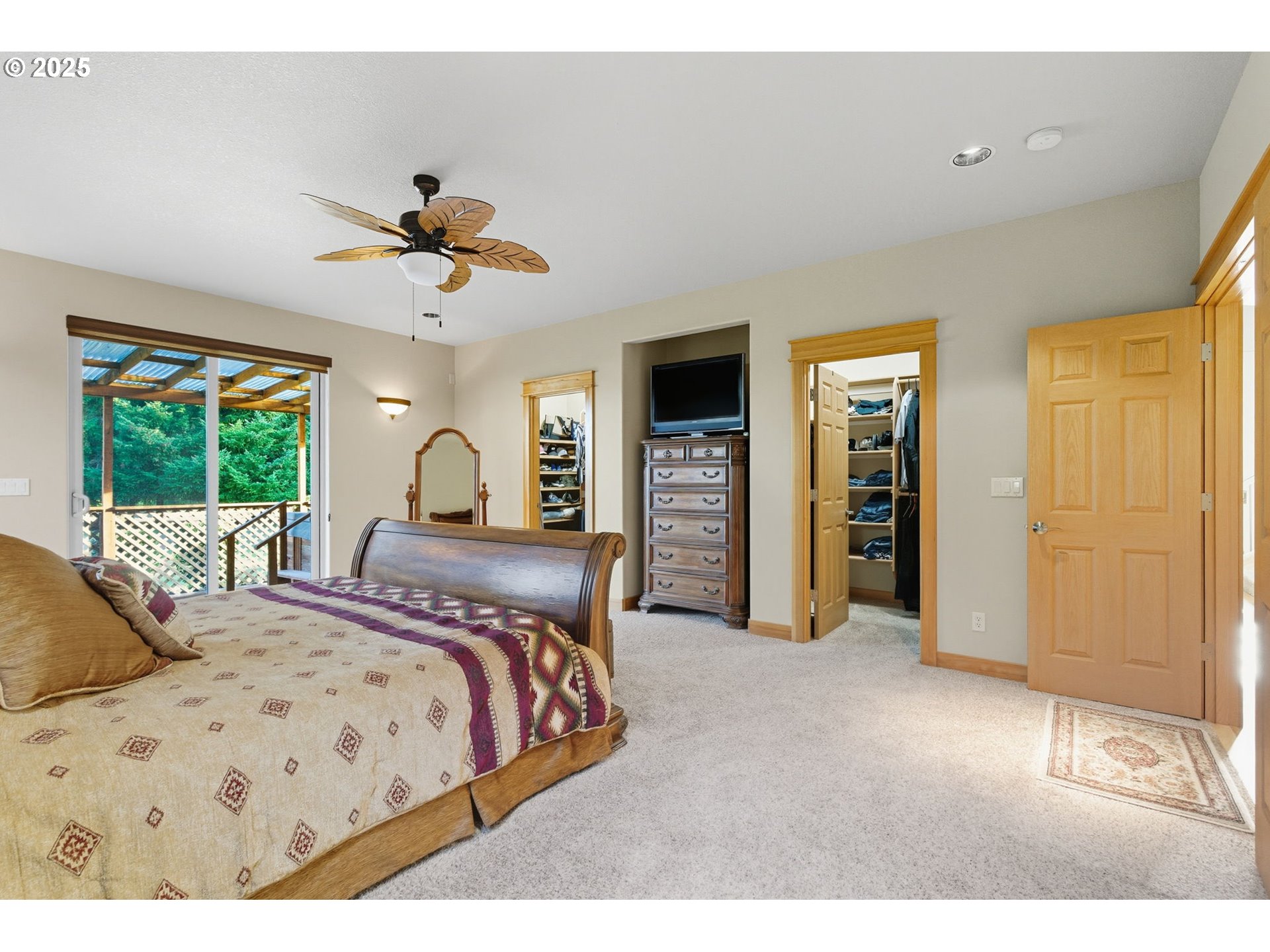 9573 South Gribble Road Canby, OR 97013 - Photo 24 of 48 a bedroom with a large bed and a chandelier