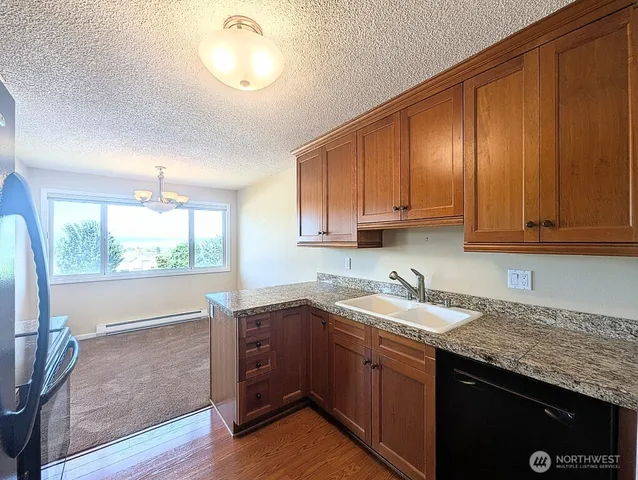 a kitchen with a sink cabinets and window