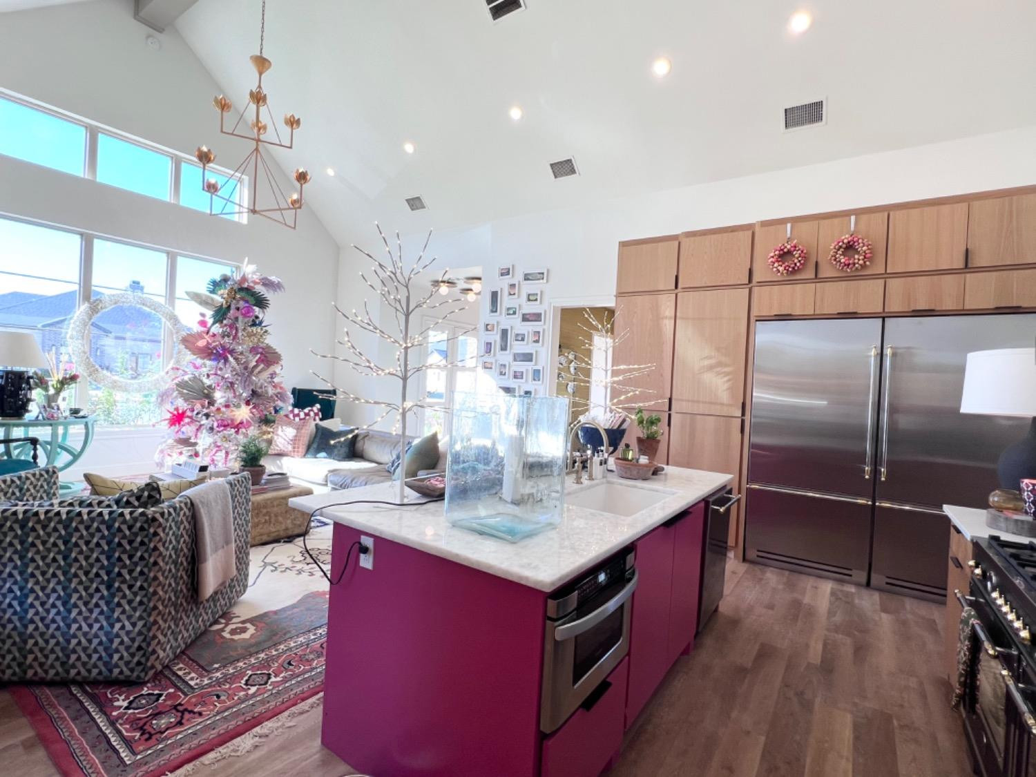 5902 112th Street Lubbock, TX 79424 - Photo 17 of 47 a kitchen with stainless steel appliances granite countertop a kitchen island a stove a refrigerator and a dining table view