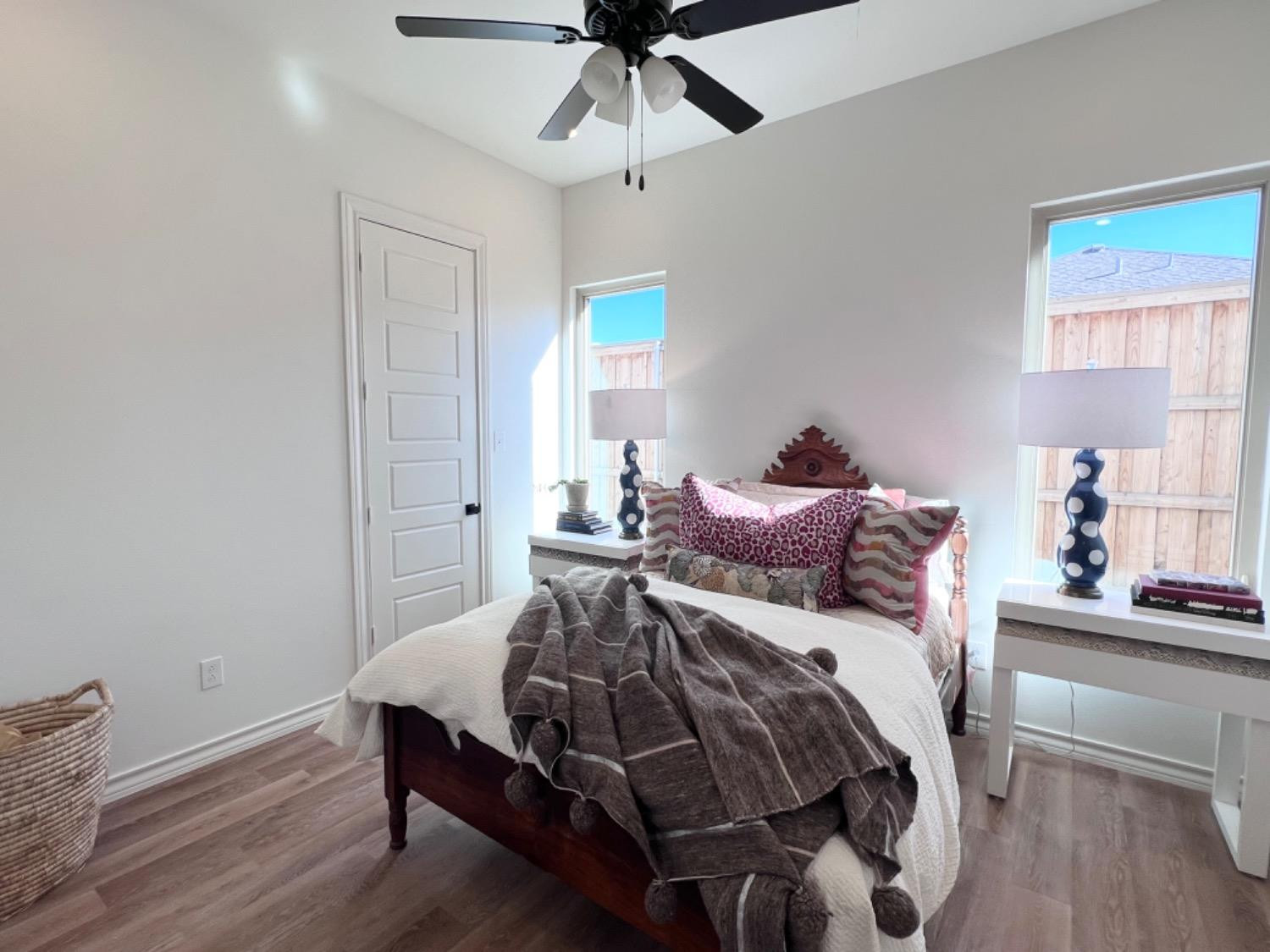 5902 112th Street Lubbock, TX 79424 - Photo 22 of 47 a bedroom with a bed and wooden floor