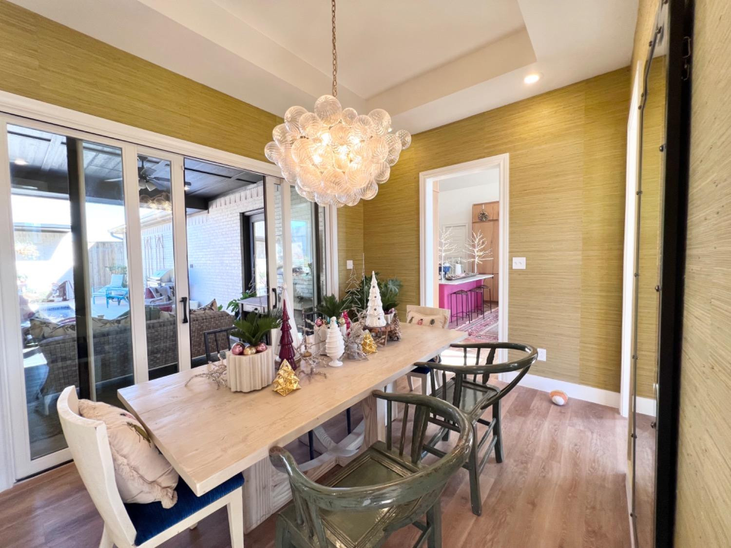 5902 112th Street Lubbock, TX 79424 - Photo 26 of 47 a view of a dining room with furniture wooden floor and chandelier