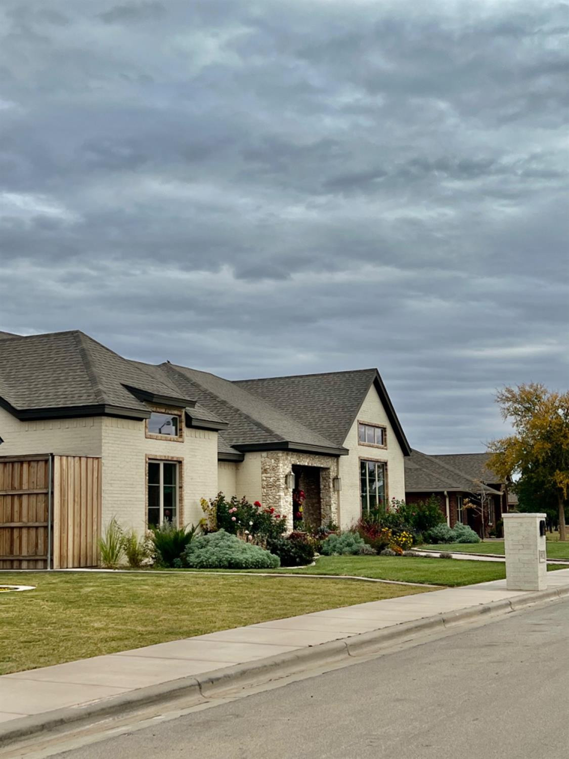 5902 112th Street Lubbock, TX 79424 - Photo 3 of 47 a front view of a house with a yard and garage