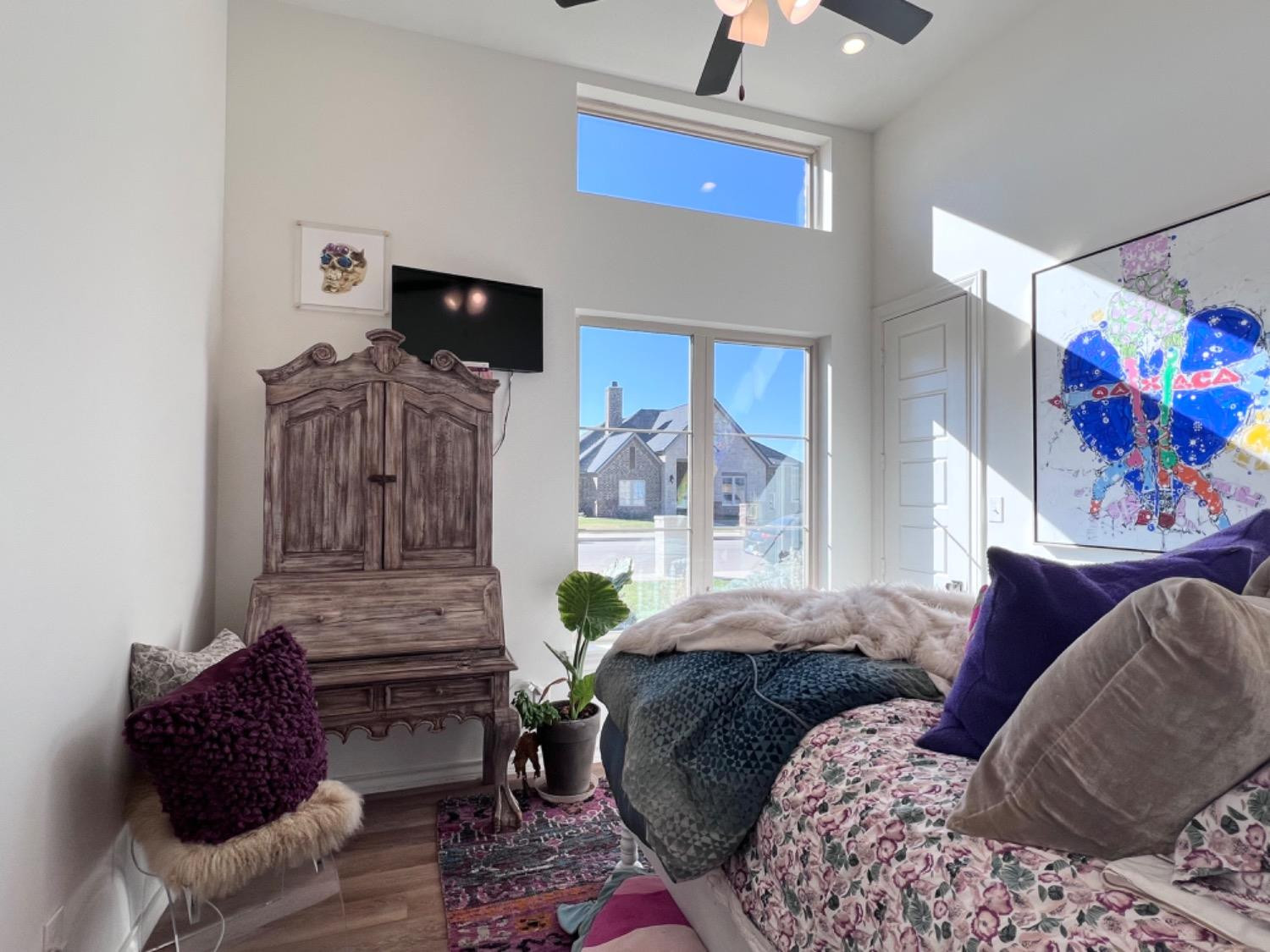 5902 112th Street Lubbock, TX 79424 - Photo 39 of 47 a bedroom with a bed and flat screen tv