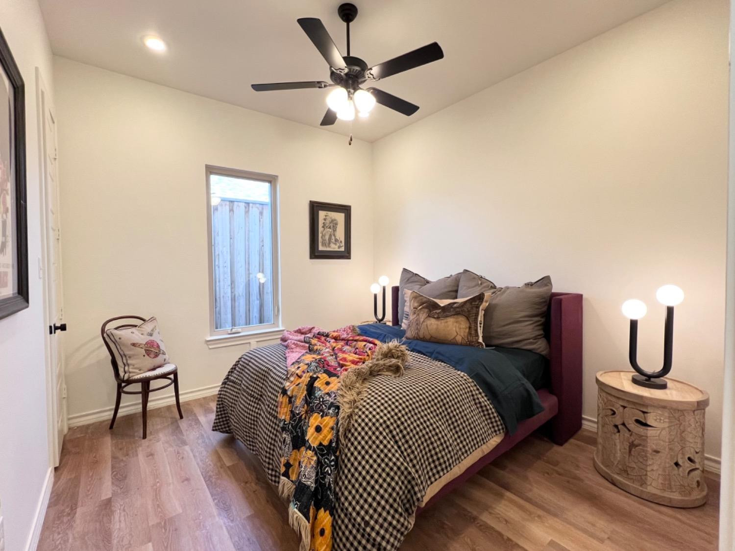 5902 112th Street Lubbock, TX 79424 - Photo 40 of 47 a bed room with a bed and a chair