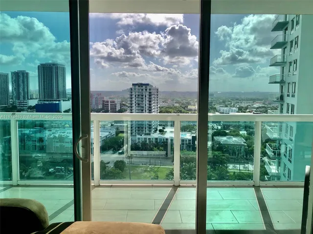 a view of a glass door with a yard