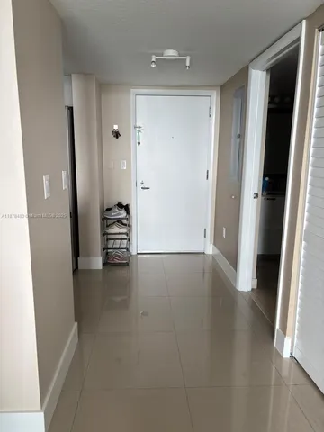 a bedroom with a bed and a lamp next to a window