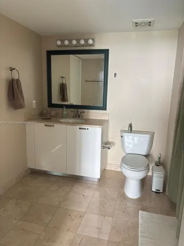 a view of a hallway with wooden floor and furniture