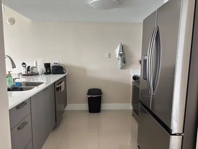 a kitchen with stainless steel appliances a refrigerator and a sink