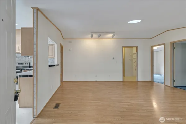 a view of a hallway with wooden floor and staircase