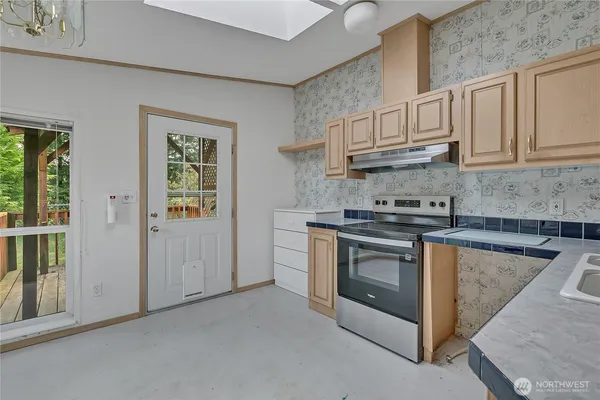 a kitchen with cabinets stainless steel appliances and a counter space