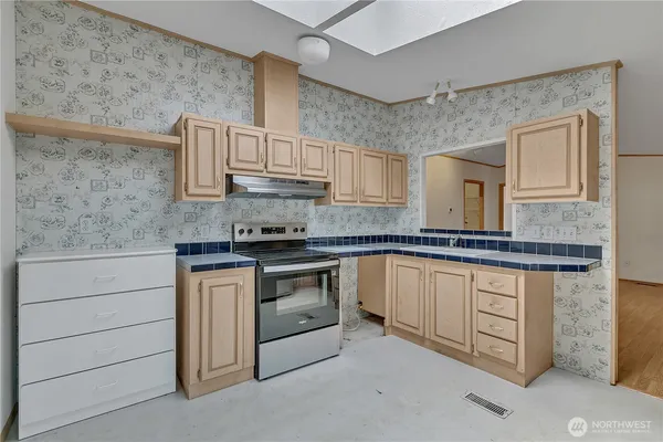 a kitchen with stainless steel appliances granite countertop a sink and cabinets
