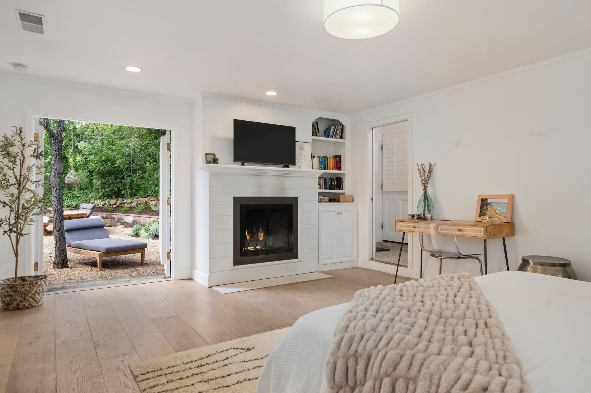 636 Oak Grove Drive Montecito, CA 93108 - Photo 11 of 17 a bedroom with a bed and a fireplace