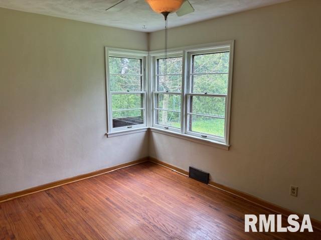 29470 Saxon Road Galva, IL 61434 - Photo 12 of 23 a view of an empty room with wooden floor and a window