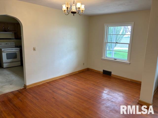 29470 Saxon Road Galva, IL 61434 - Photo 15 of 23 an empty room with wooden floor chandelier and windows