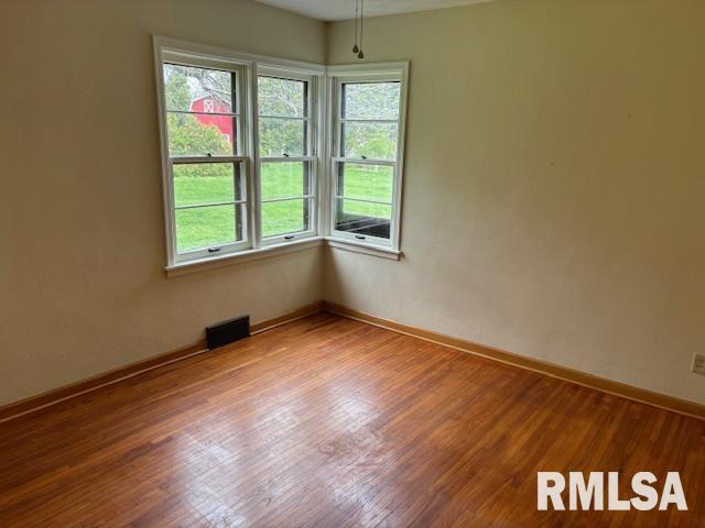 29470 Saxon Road Galva, IL 61434 - Photo 8 of 23 an empty room with wooden floor and windows