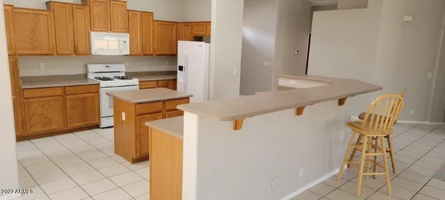 a kitchen with a refrigerator a stove a sink and cabinets