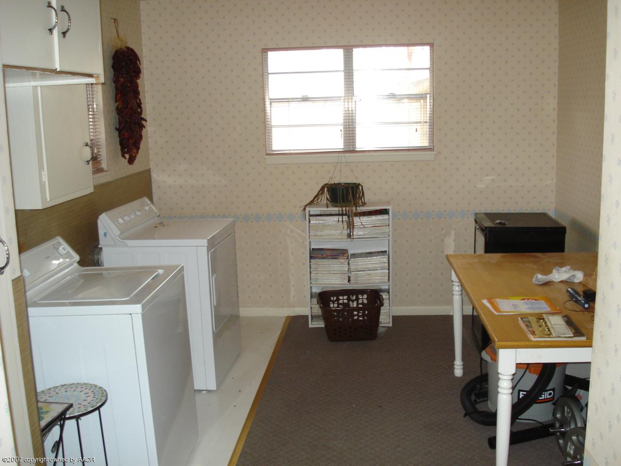 6115 Gainsborough Road Amarillo, TX 79106 - Photo 3 of 13 a view of a workspace with furniture and a window
