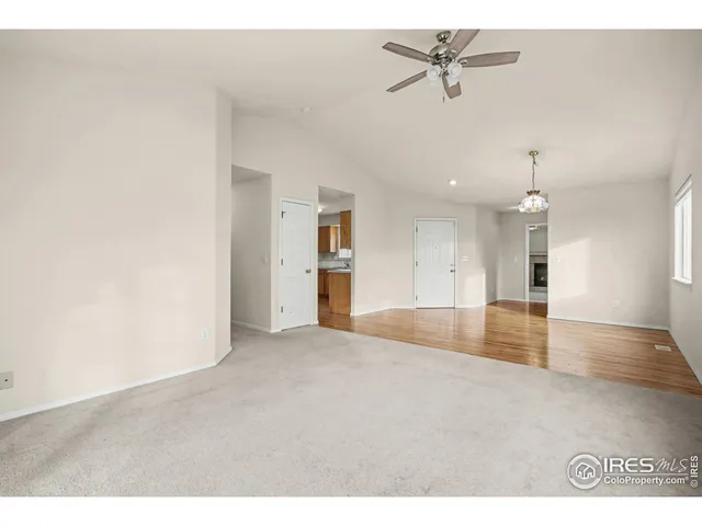 a view of a kitchen with a sink and a chandelier fan
