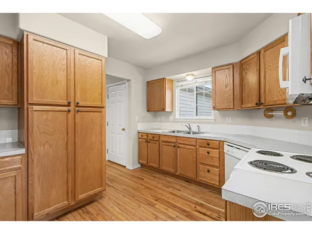 a kitchen with a refrigerator sink and cabinets