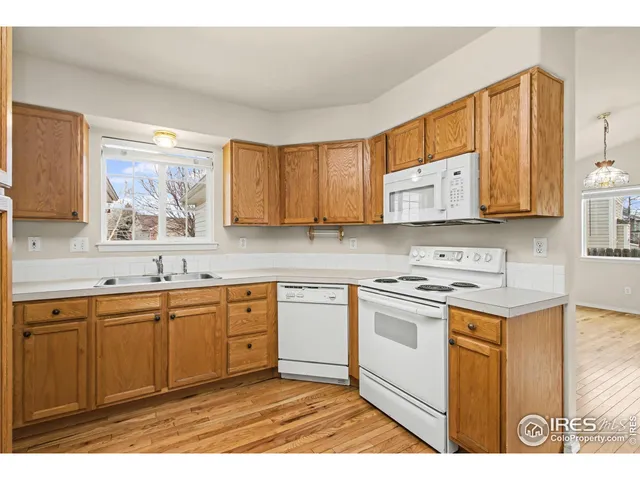 a kitchen with stainless steel appliances granite countertop a stove a sink a microwave and cabinets
