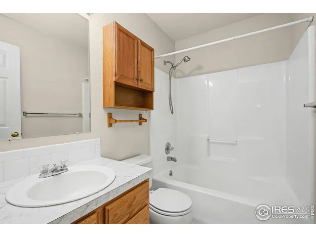 a bathroom with a sink toilet a mirror and shower
