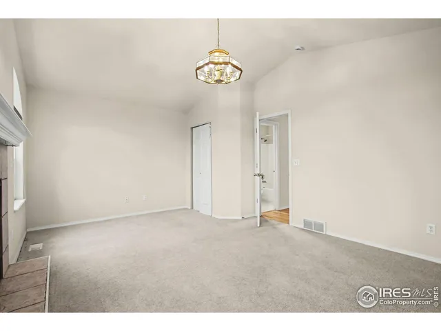 a view of an empty room and a window