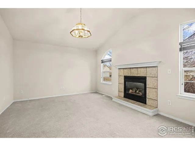 a view of an empty room with a fireplace
