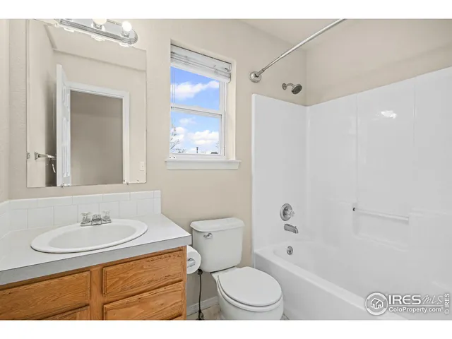 a bathroom with a sink toilet a mirror and shower