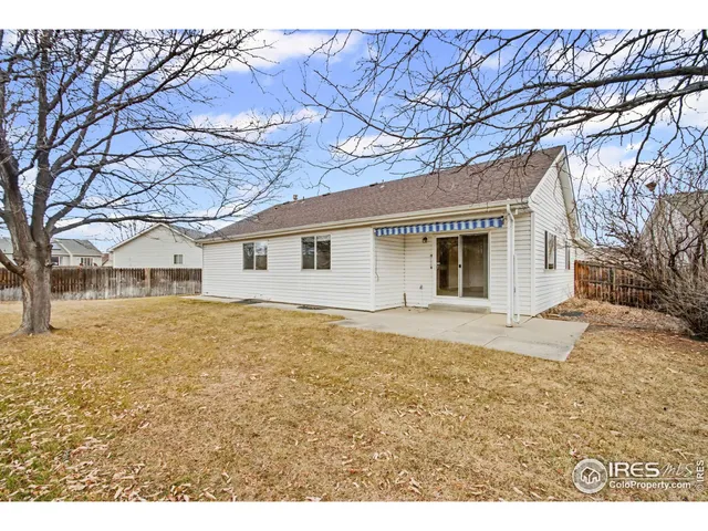 a view of a house with a yard covered in snow