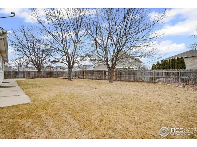 a view of yard covered with snow in front of house