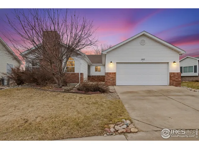 a view of a house with a yard and garage