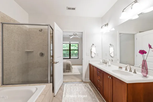 a spacious bathroom with a double vanity sink and a mirror