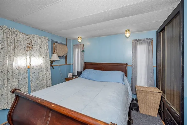 a bed sitting in a room next to a window