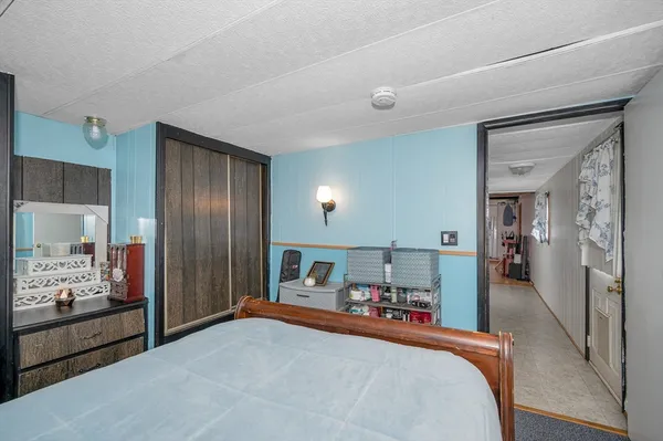 a bedroom with a bed and a large mirror