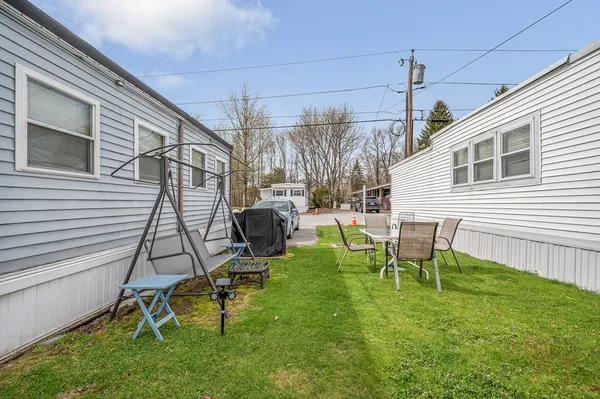 a view of a house with patio and a yard