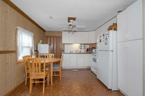 a kitchen with cabinets and refrigerator