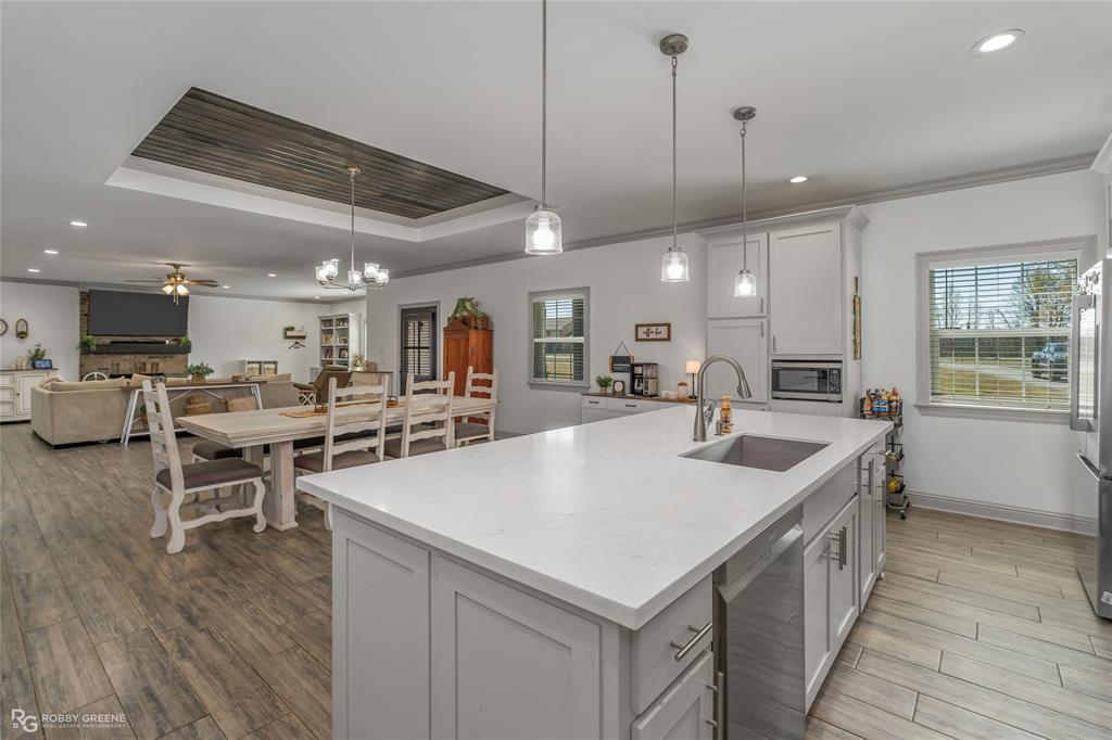 396 Collinswood Road Stonewall, LA 71078 - Photo 18 of 32 a large kitchen with a table and chairs
