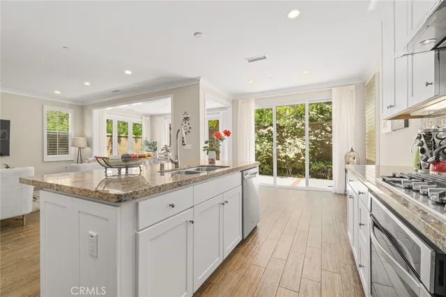 a kitchen with granite countertop a stove and a sink