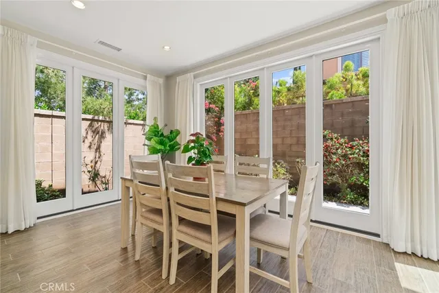 a dining room with furniture window and wooden floor