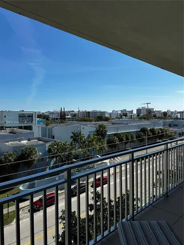 a living room with furniture a flat screen tv and a large window