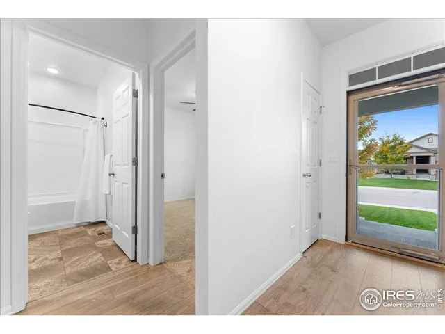 an empty room with windows and entrance