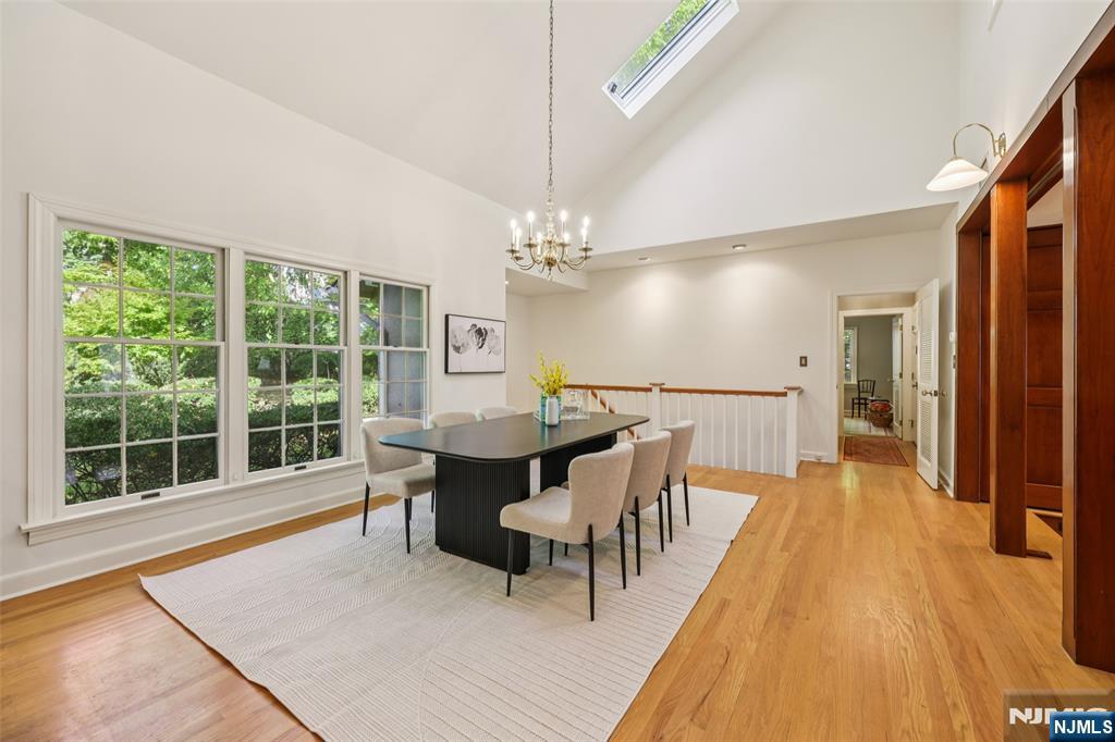 119 Sheridan Terrace Ridgewood, NJ 07450 - Photo 12 of 44 a dining room with furniture a chandelier and wooden floor