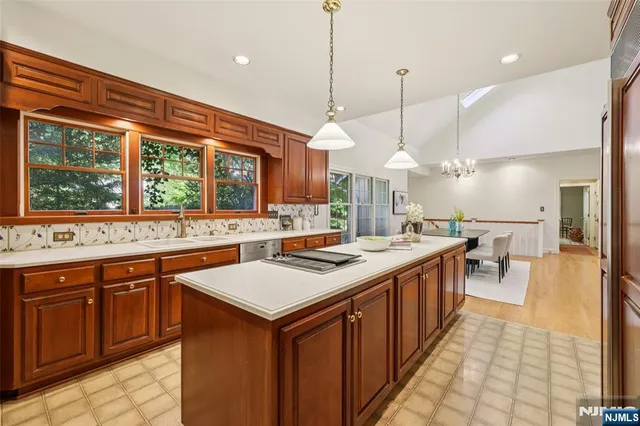 a kitchen with a stove sink and a wooden floor
