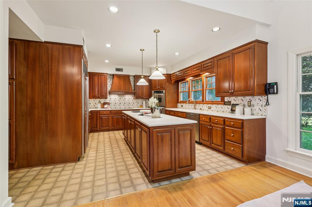 119 Sheridan Terrace Ridgewood, NJ 07450 - Photo 14 of 44 a kitchen with stainless steel appliances granite countertop a stove a sink dishwasher and a refrigerator