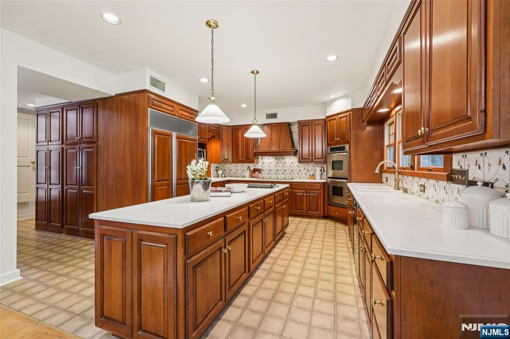 119 Sheridan Terrace Ridgewood, NJ 07450 - Photo 15 of 44 a large kitchen with stainless steel appliances granite countertop a sink and a refrigerator