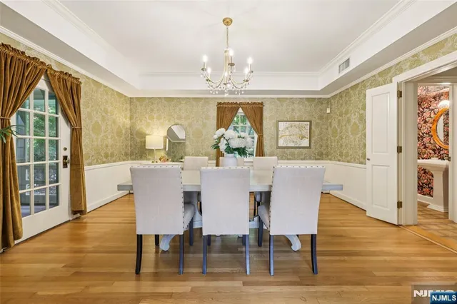 a view of a a dining room with furniture window and wooden floor